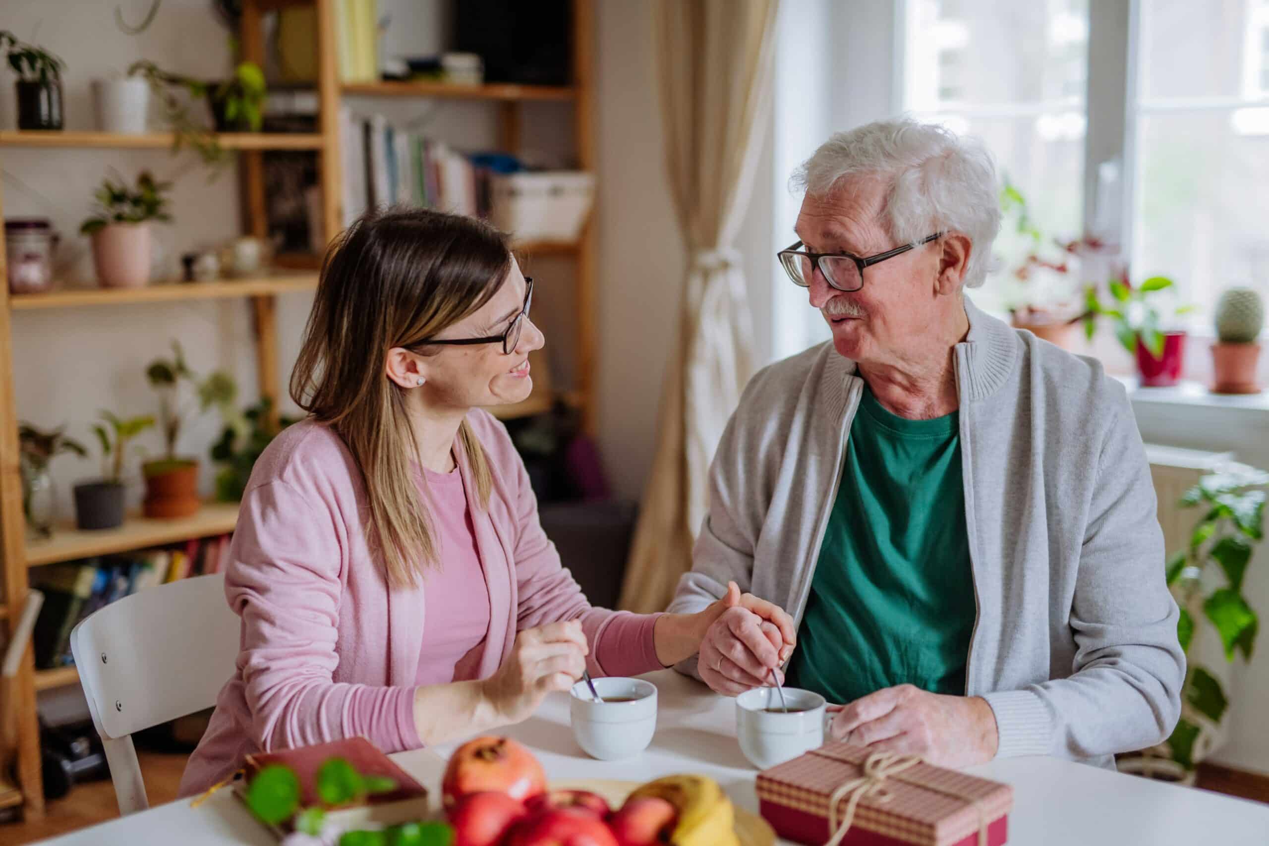 Man and woman smiling over cup of tea